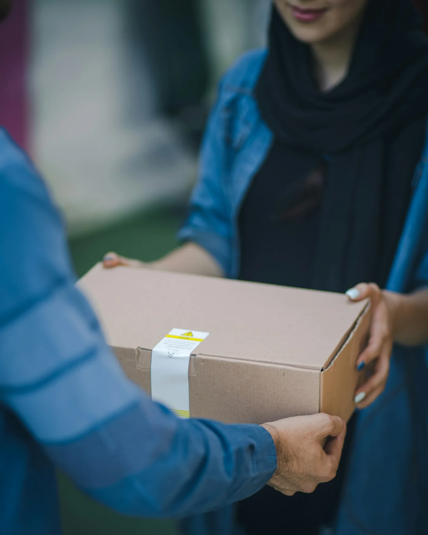 A parcel handed over on a doorstep, the lead image across the Cheetah Logistics site
